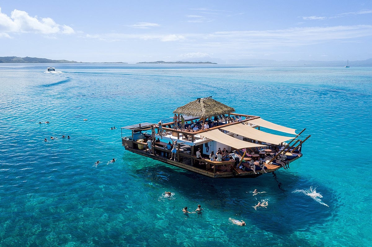 Cloud 9 is a floating deck in the middle of the South Pacific Ocean, surrounded by crystal clear waters and a beautiful reef